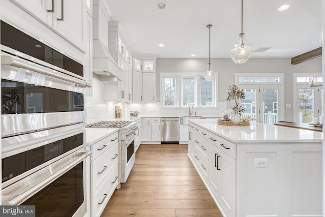 kitchen featuring a healthy amount of sunlight, light wood-style floors, visible vents, and stainless steel appliances