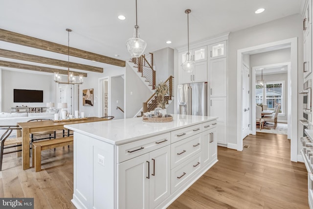 kitchen with high end refrigerator, light wood-type flooring, white cabinetry, pendant lighting, and recessed lighting