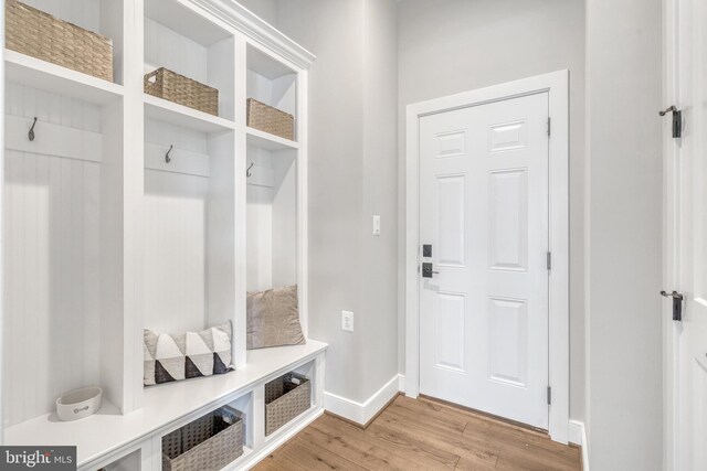 mudroom featuring light wood-style floors and baseboards