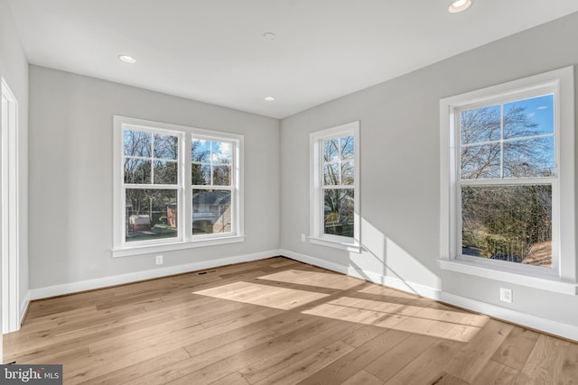 spare room with recessed lighting, baseboards, and hardwood / wood-style floors