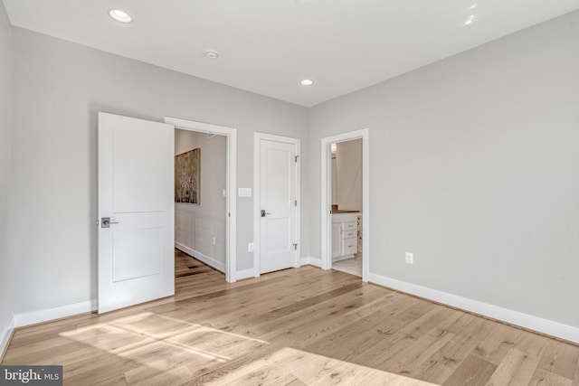 unfurnished bedroom featuring recessed lighting, baseboards, and light wood finished floors