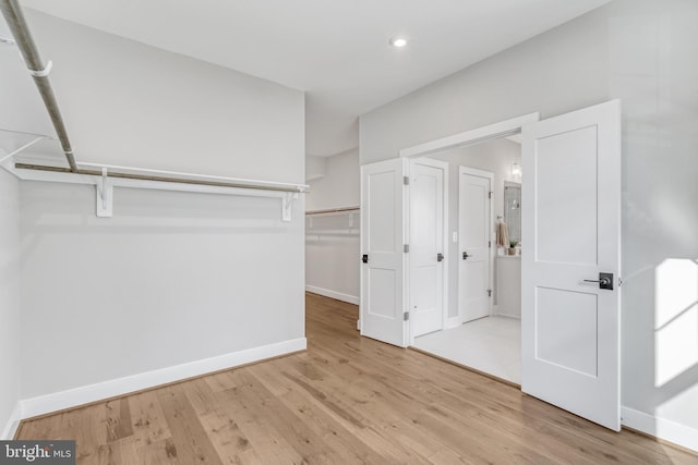 walk in closet featuring light wood-style flooring