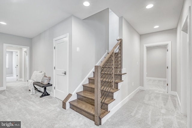 staircase featuring carpet floors, recessed lighting, and baseboards