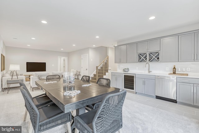 dining area with light tile patterned floors, wine cooler, stairway, indoor wet bar, and recessed lighting