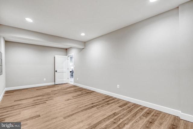 below grade area with recessed lighting, wood finished floors, and baseboards