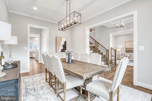 dining room with ornamental molding and wood finished floors