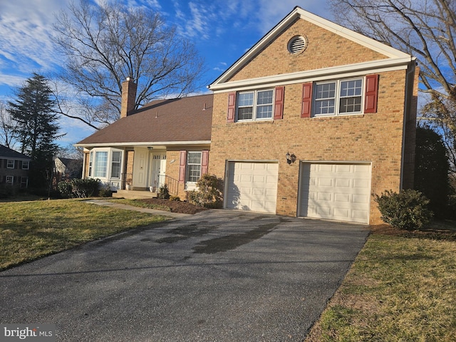 traditional home with a garage, driveway, brick siding, and a chimney