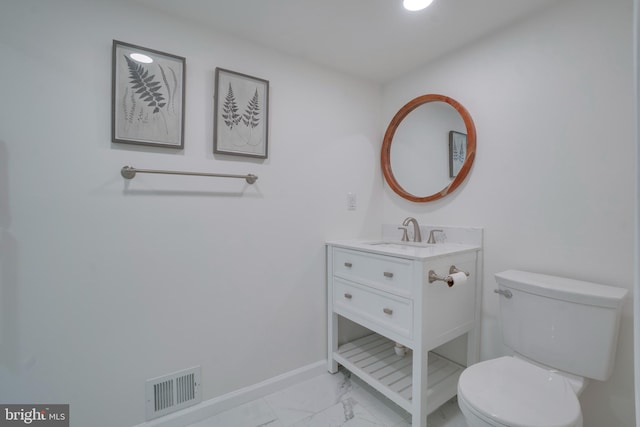 bathroom with marble finish floor, visible vents, toilet, vanity, and baseboards