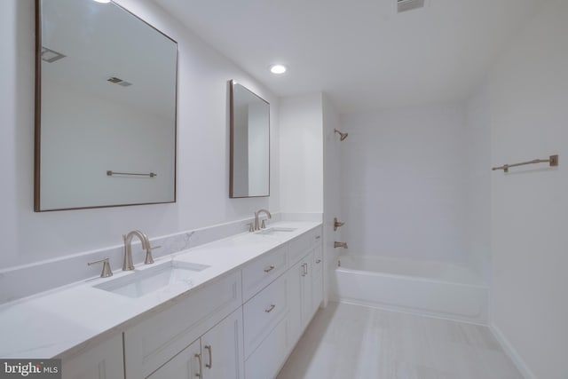 full bathroom with double vanity, shower / bathing tub combination, a sink, and visible vents