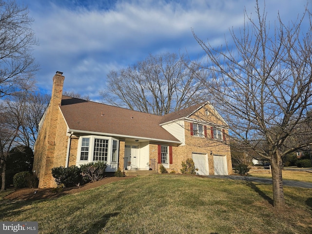 tri-level home with brick siding, a chimney, a front yard, a garage, and driveway