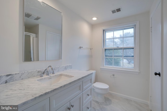 full bathroom with baseboards, visible vents, vanity, and toilet