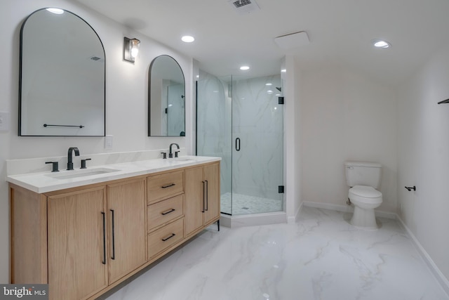 bathroom featuring marble finish floor, a marble finish shower, a sink, and toilet