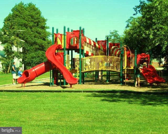 communal playground featuring a yard