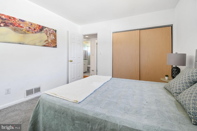 bedroom with carpet, visible vents, and a closet