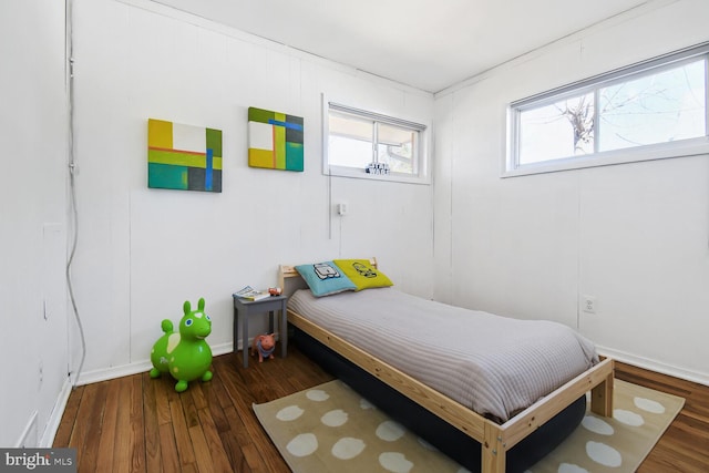 bedroom with baseboards and wood finished floors