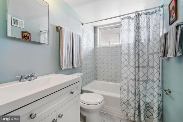 full bathroom featuring toilet, shower / tub combo, visible vents, and vanity