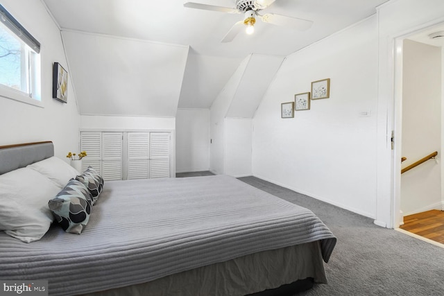 carpeted bedroom featuring lofted ceiling, ceiling fan, and baseboards