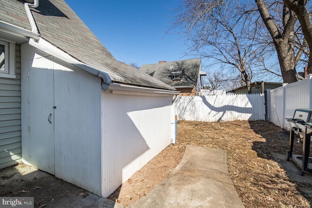 view of side of property featuring fence