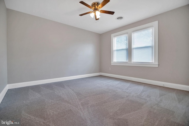 empty room featuring a ceiling fan, carpet, visible vents, and baseboards