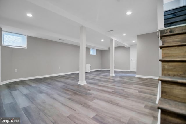 basement featuring visible vents, baseboards, wood finished floors, and recessed lighting