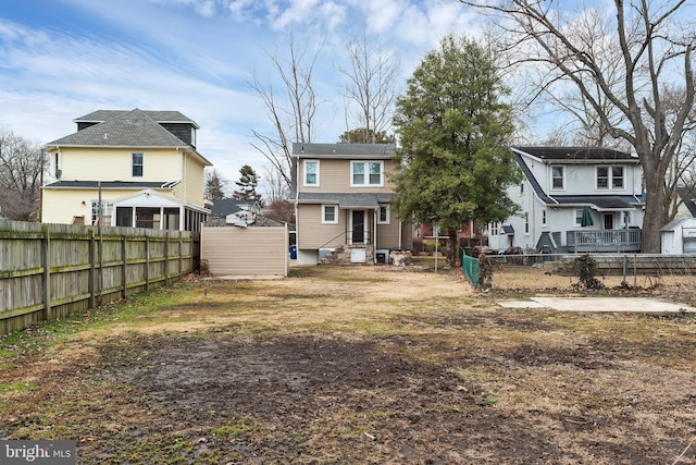 back of property featuring fence private yard and a residential view