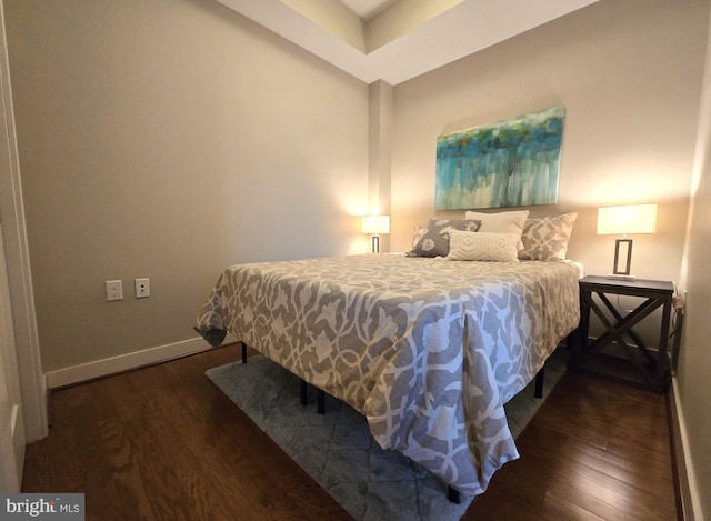 bedroom featuring baseboards and wood finished floors