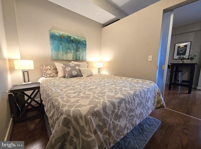 bedroom featuring wood finished floors and baseboards