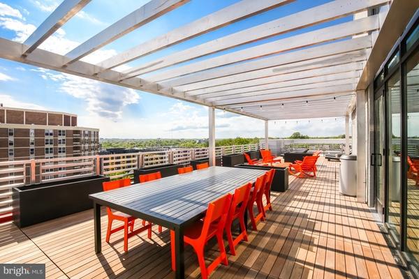 wooden deck with outdoor dining area and a pergola