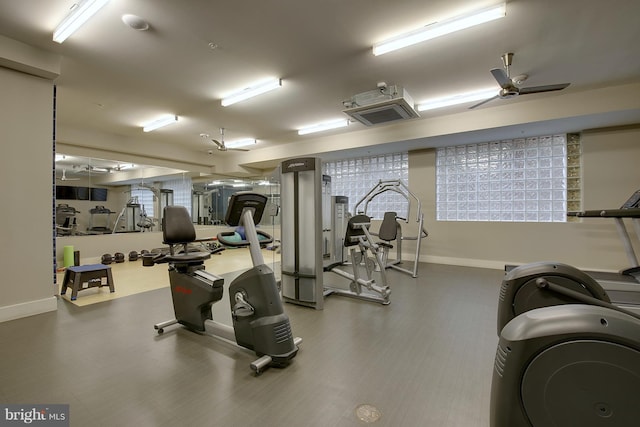 exercise room featuring a ceiling fan and baseboards