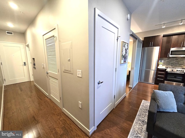 hallway with dark wood finished floors and baseboards