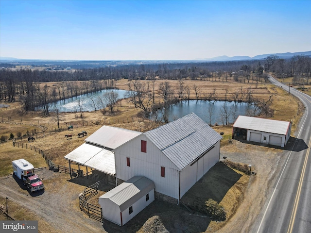 birds eye view of property with a water view and a rural view