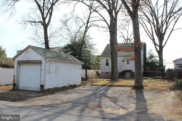 detached garage featuring fence