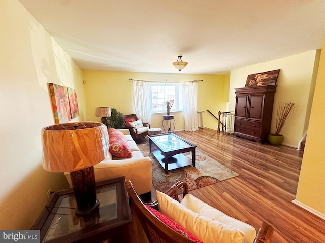 living area with wood finished floors and baseboards