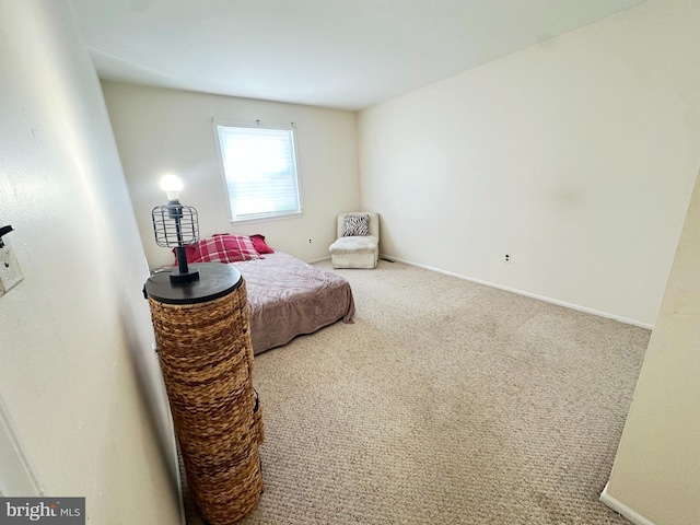 bedroom featuring carpet and baseboards