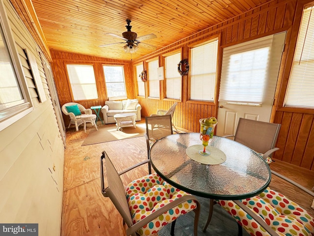 sunroom with wood ceiling and ceiling fan