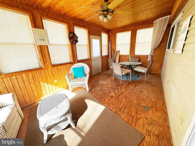 sunroom featuring ceiling fan and wooden ceiling