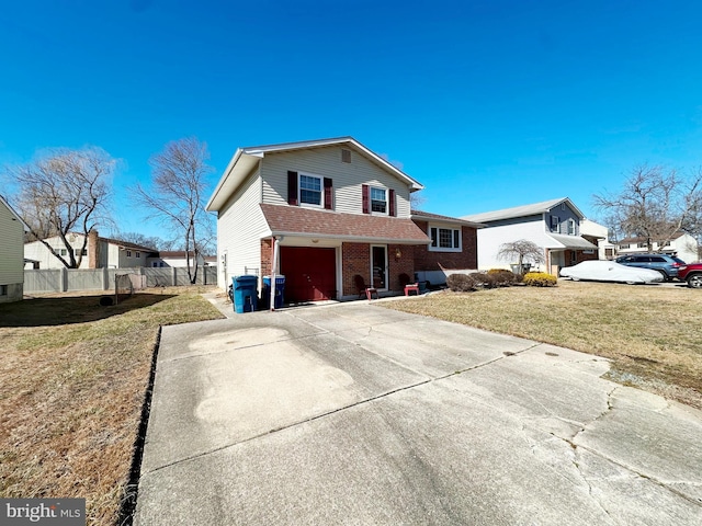 view of front facade featuring brick siding, fence, a garage, driveway, and a front lawn