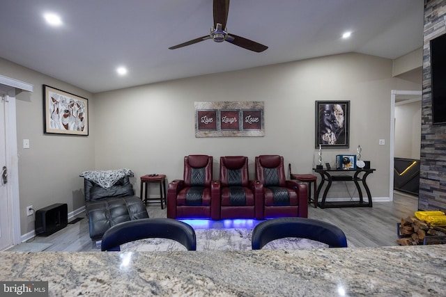 living room featuring lofted ceiling, ceiling fan, recessed lighting, wood finished floors, and baseboards