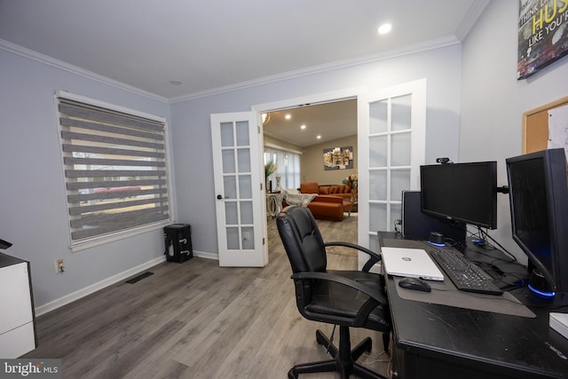 office featuring baseboards, visible vents, ornamental molding, wood finished floors, and french doors