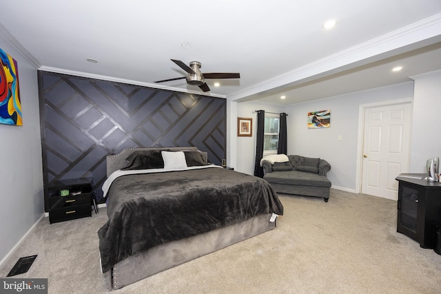 carpeted bedroom featuring recessed lighting, an accent wall, visible vents, baseboards, and crown molding