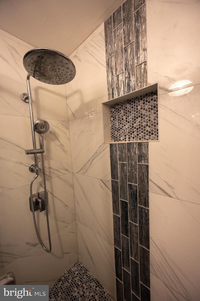 full bathroom with a tile shower