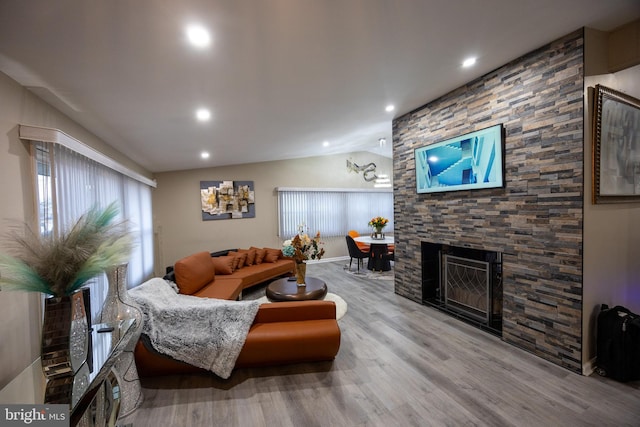 living area with lofted ceiling, a fireplace, wood finished floors, and recessed lighting