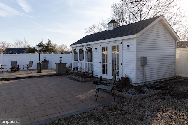 view of outdoor structure featuring an outbuilding and a fenced backyard