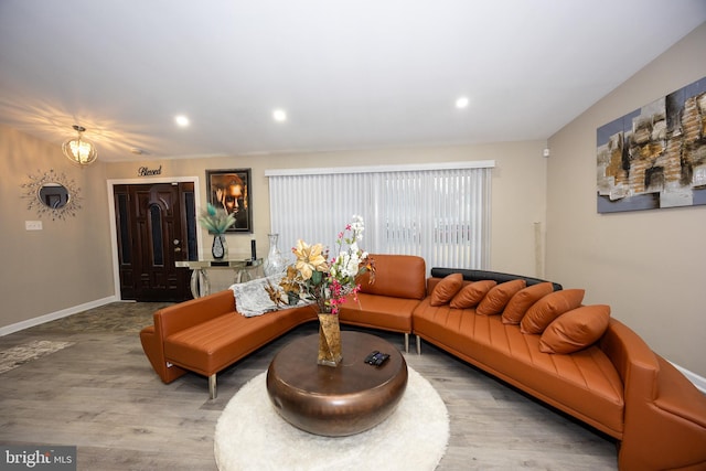 living area featuring recessed lighting, wood finished floors, and baseboards