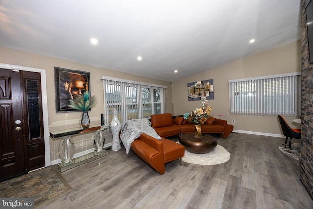 living area with lofted ceiling, baseboards, wood finished floors, and recessed lighting