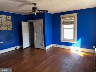 unfurnished bedroom featuring baseboards and wood finished floors