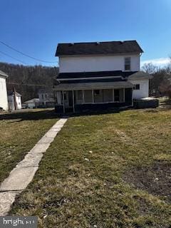 back of house featuring a lawn