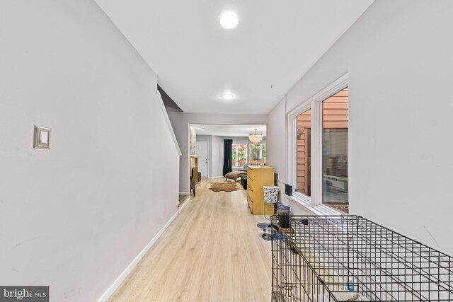 hall with wood finished floors and baseboards