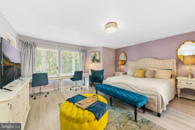 bedroom with baseboards and light wood-style floors