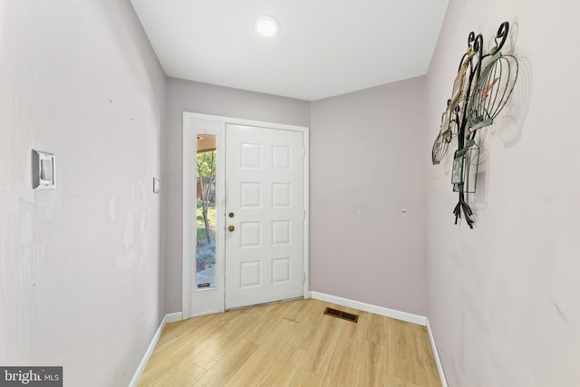 entrance foyer featuring light wood-type flooring, visible vents, and baseboards